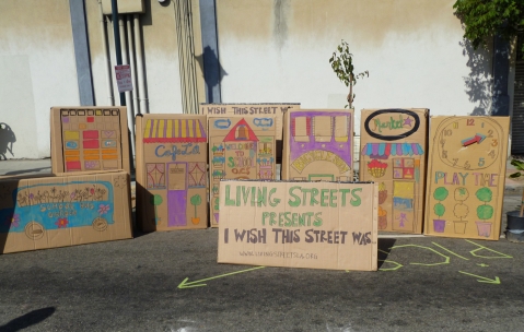 Cardboard storefront facades painted by participants of "I Wish This Street Was..." presented by Living Streets Los Angeles at CicLAvia. Photo by Living Streets Los Angeles