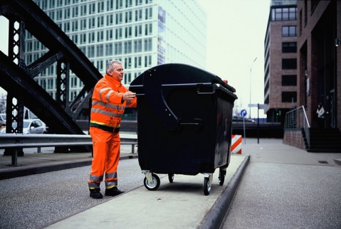 Garbageman Hans-Dieter Braatz sets up a photo with a pinhole camera fashioned out of a garbage dumpster. Photo by Mirko Derpmann