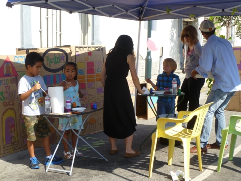 Children painting with their parents for "I Wish This Street Was..." presented by Living Streets Los Angeles at CicLAvia. Photo by Living Streets Los Angeles