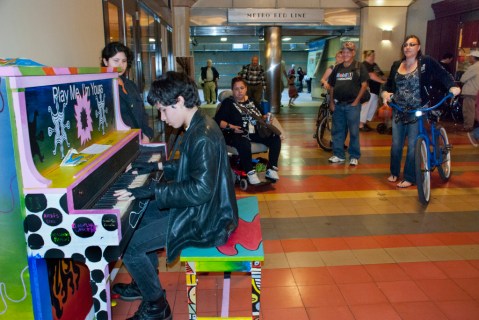 People gather to watch a budding musician at Union Station in Los Angeles. Photo by The MetroDuo Blog