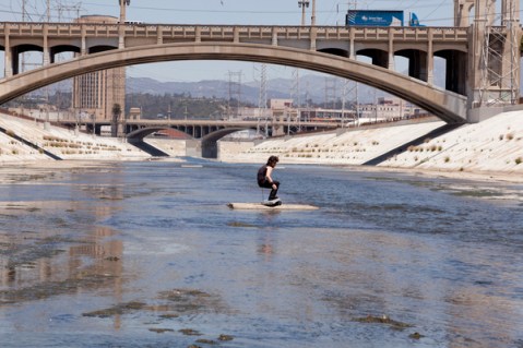 Surfer in the Los Angeles River by Calder Greenwood. Photo by Stephen Zeigler via KCET Departures. 