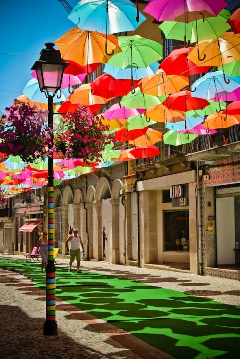 A colorful canopy of umbrellas, a part of the Agitagueda art festival in Águeda, Portugal. Photo by Patrícia Almeida